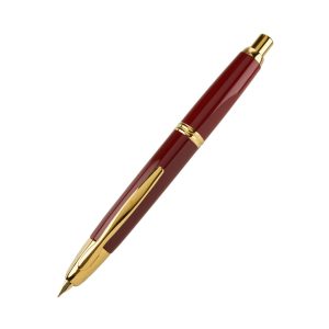 Pilot Capless is the world's first retractable fountain pen developed and commercialized by a pilot, and has been a long-selling product for almost half a century since its launch in 1963. It can be written quickly like a retractable ballpoint pen, and when storing the nib, the highly airtight shutter mechanism prevents ink leakage and drying. Because of its original ideas and excellent functionality, it has gained a high reputation all over the world. Pilot Capless Fountain Pen Red comes with Gold Plated trims and is Cartridge, Converter (Included) filling mechanism. It is enhanced with a 18K Gold nib made inhouse by Pilot. It comes packaged in a nice and elegant gift box. Series: Pilot Capless Decimo (FC1500 RG) M Colour: Red with Gold Accents Material: Brass Slim and long-shaped nib gives easier control of pen tip when you write. Well-designed clip is not obstructive to your hand. Special shutter mechanism keep the nib from drying out. Nib : 18K Gold Medium Nib Fountain pen with 18K Gold nib and ebonite feed. Converter is included with the pen. Brand Origin: Japan
