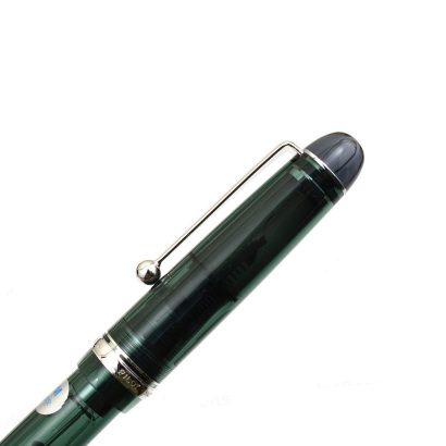 The Pilot Custom 74 is often considered to be one of the best “next step” pens for people who have decided to delve more deeply into the fountain pen hobby. It is an entry to the world of gold nibs. The Custom 74 is a classically designed fountain pen, simple yet sophisticated. The shape is traditional, with a rounded-end barrel design and a classic Pilot clip shape. The translucent barrel adds a modern touch, especially with some of the fun colors Pilot has chosen. It is a very light weight pen, perfect for long writing hours. The Custom 74 feature a relatively stiff, rhodium-plated 14k Pilot nib that offers a super smooth writing experience. Model : Custom 74 Tinted Green Body Colour: Tinted Green Trim : Chrome plated Fill Mechanism : Converter or Cartridge (included converter) Body Material : Resin Nib : 14KT Gold, Medium Nib  Gift Box Made in Japan