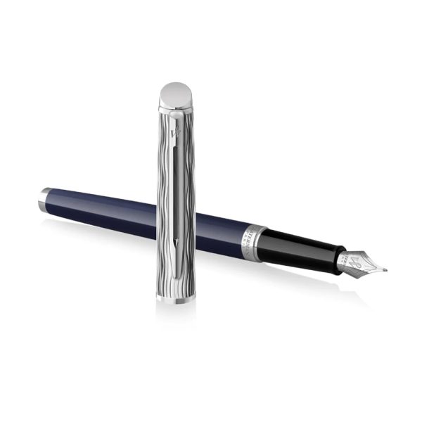 The Waterman Hemisphere L'Essence Du Bleu CT Fountain Pen is a stylish and elegant writing instrument produced by Waterman. the fashionable L’Essence du Bleu Hémisphère fountain pen is finished in a vibrant, deep blue lacquer with Waterman’s signature wave pattern chiselled into the metal cap. The fountain pen feature the Waterman double-branched clip, stainless steel nib with the looped W Waterman design and complemented by palladium trim. Waterman Hemisphere L'Essence Fountain Pen is a presented in a prestige gift box. Deep Blue colour  Lacquer coated Brass barrel with a signature wave pattern on the cap Palladium plated cap and trim It uses standard size converter or cartridges Engraved Stainless steel nib - Fine  Fountain pen is presented in a beautiful waterman gift box. Country of Origin: India