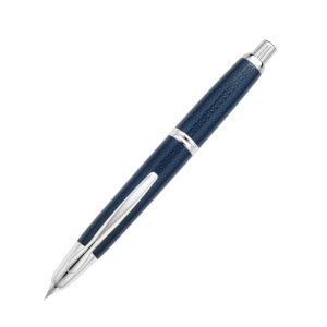 Pilot Capless Kasuri Blue Rhodium Trim Fountain Pen a.k.a Carbonesque in Europe due to the similarity of a carbon-fibre finished. This finish is actually known as the Kasuri in Japan. Kasuri is a Japanese word for fabric that has been woven with fibers dyed specifically to create patterns and images in the fabric. It is an ikat (resist-dyeing) technique. The patterns are characterized by a blurred or brushed appearance which is reflected in this pen. Body Colour: Kasuri Blue Series: Capless Kasuri (kasuri) Product Number : 2082 - 1500RRR-M-L Material : Metal Trim : Rhodium Cap Type : Capless Nib : 18Kt rhodium-plated gold Medium Nib Converter Included : Yes Method - Knock type Fill Mechanism : Cartridge/Converter (CON-40 *Cartridge ink can also be used.) Packaging Type : Gift Box Packaging Made in Japan