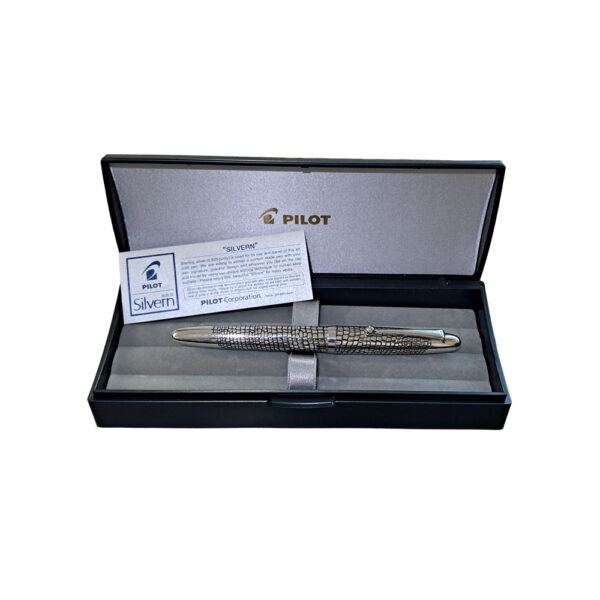 The Pilot Sterling Silver Ishidatamu CT Fountain Pen is a beautiful fountain pen in Pilot's Silvern collection. The pen's barrel and cap are made of genuine sterling silver, giving it a nice weightiness in the hand. This fountain pen features a rhodium-plated 18k gold inlaid nib. A CON-40 converter is included with each pen, but they will also accept Pilot proprietary ink cartridges. Ishidatami is the name of the pattern that is etched into barrel and cap. In Japanese, ishidatami ("stone paving") refers to stones that were used to pave rough roads, especially on steep mountain passes. These paved roads used large stones carefully composed to give travelers sure footing, which improved travel dramatically during the Edo era. Some portions of these roads are beautifully preserved and have inspired artists in Japan over time. The small, irregular lines engraved on the Pilot Sterling Silvern Ishidatami capture the image of old Japanese cobblestone perfectly. The overall weight of a pen in the Sterling collection is around 34 grams, making it fairly comparable to the Pilot Metal Falcon. While tarnishing may be a concern given the material of the pen, the included polishing cloth will ensure easy, convenient cleaning of the pen body to keep away blemishes. The design on each pen will not hinder this cleaning either and allows for thorough, complete polishing. Model : FK5MSIDMINT Made From 925 Sterling Silver barrels and caps with stone paving Pattern Material: 925 Silver Snap Cap with Silver Plated trim Fountain pen comes with a Pilot CON-40 converter Nib : 18kt Gold Rhodium-plated inlaid nib Fountain pen is presented in a beautiful Pilot gift box. Brand Origin: Japan